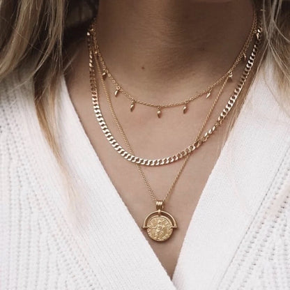 Gold coin pendant necklace featuring a medallion design, layered on model’s neck — Aurelia Medallion Necklace by MiaPromise.