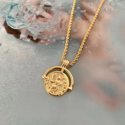 Gold coin pendant necklace featuring a medallion design, layered on model’s neck — Aurelia Medallion Necklace by MiaPromise.