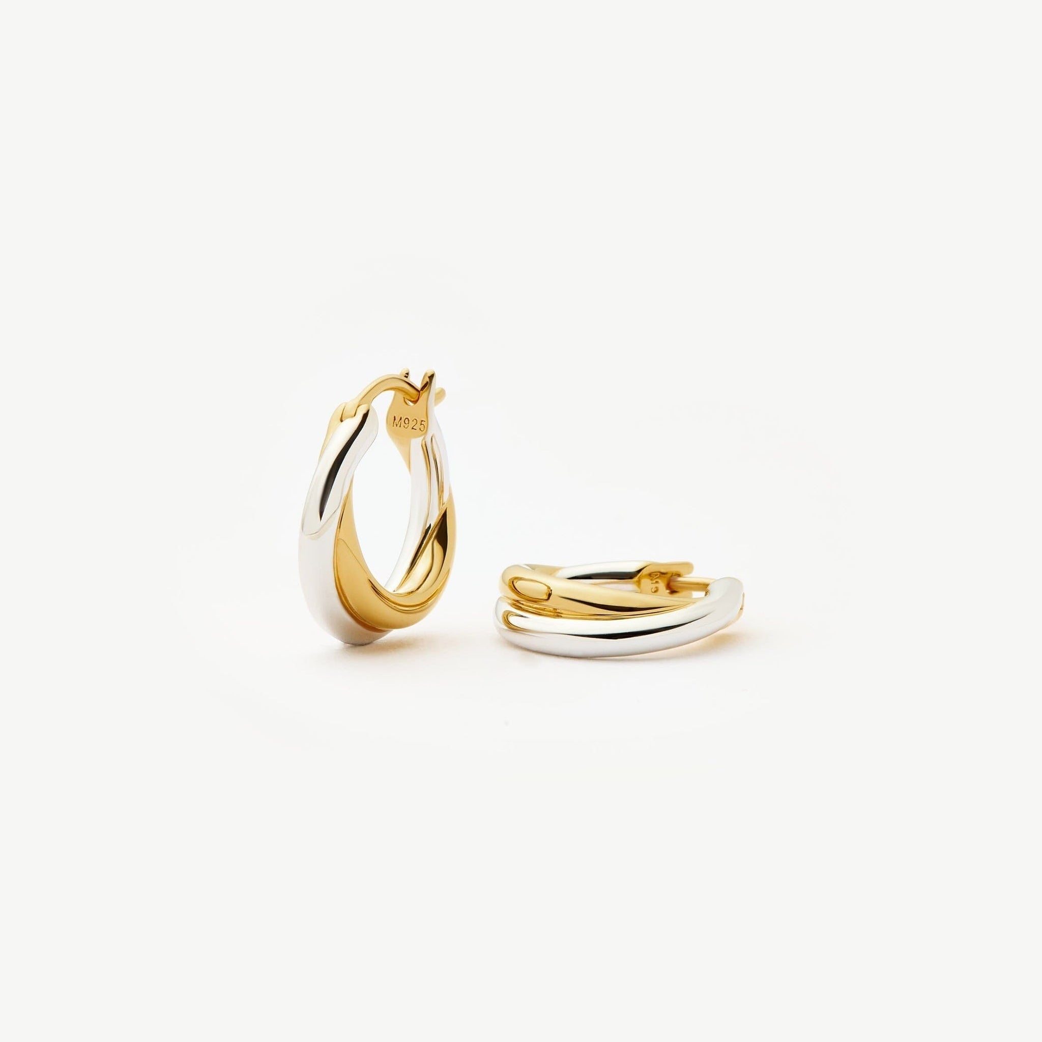 Two-tone gold and silver Luna Twist Hoops styled in ear, showcasing sculptural minimal design 00100