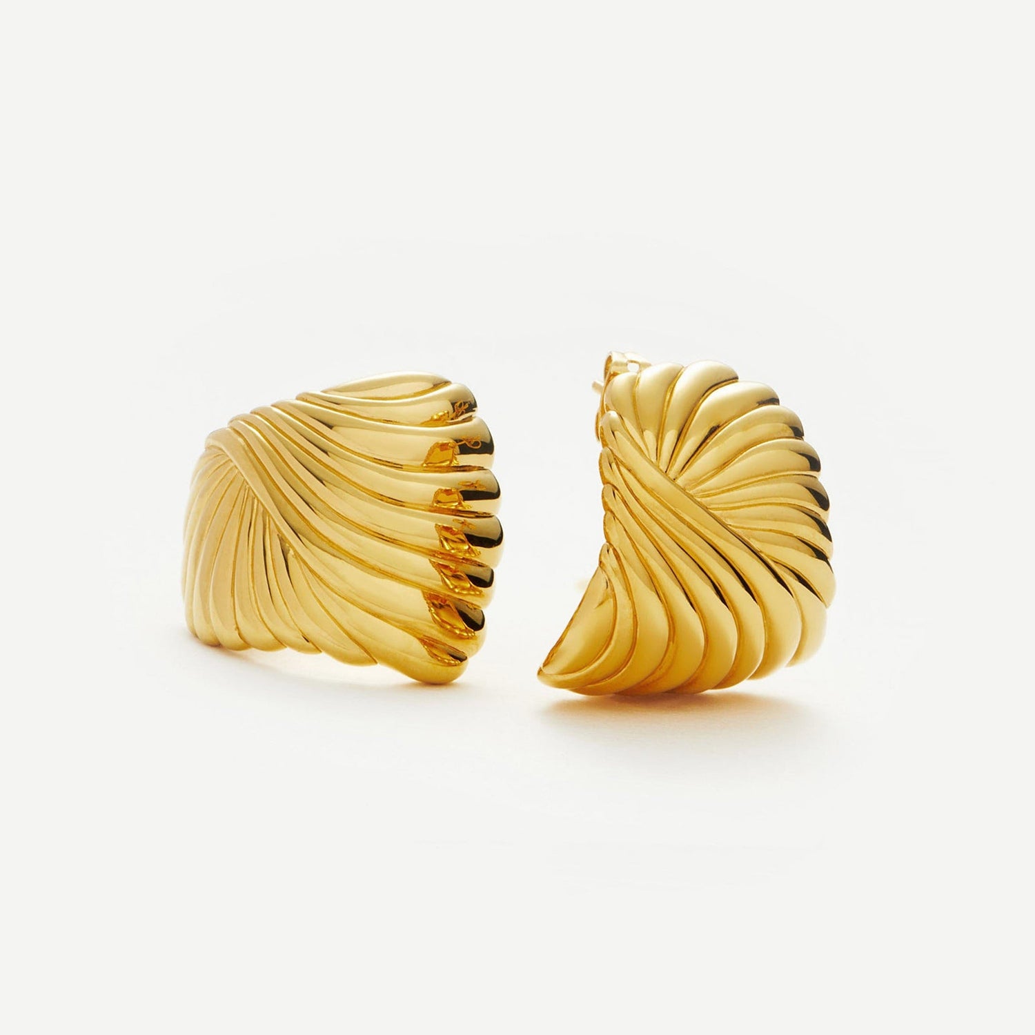 Sculptural gold feather earrings inspired by wind and movement, bold yet elegant with curved design — Zephyr by MiaPromise.